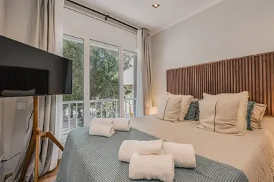 a bedroom with a large bed with white pillows at NEW Refurbished Modern Apartment in Barcelona