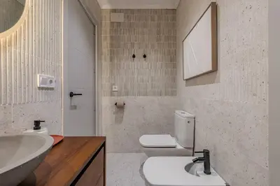 a bathroom with a sink and a toilet and a mirror at NEW Refurbished Modern Apartment in Barcelona