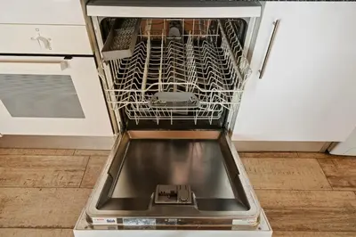 a dishwasher with its door open in a kitchen at Sants Apartment in Barcelona