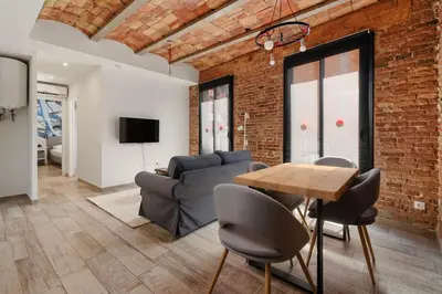 a living room with a couch and a table at Sants Apartment in Barcelona