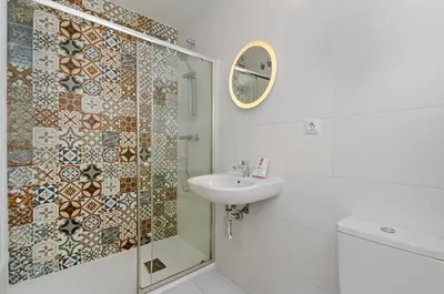 a white bathroom with a sink and a shower at Sants Apartment in Barcelona