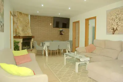 a living room with a couch and a table at casa vacacional con piscina privada in Sant Cebrià de Vallalta