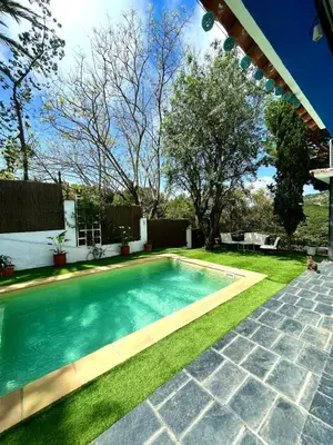 a swimming pool in the yard of a house at Casa familiar con piscina cerca del mar y montaña in San Pol de Mar
