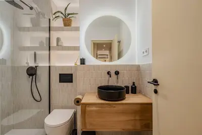a bathroom with a sink and a toilet and a mirror at Bright Apartment in Barcelona in Barcelona