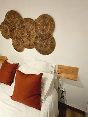 a bedroom with a bed with four umbrellas on the wall at Poolside Apartment Barcelona Sant Cugat in Sant Cugat del Vallès
