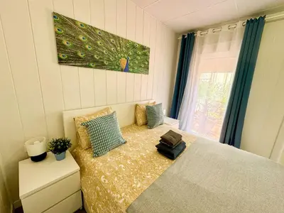 a bedroom with a bed and a picture on the wall at Sunny Terrace Apartment in Santa Coloma de Gramanet