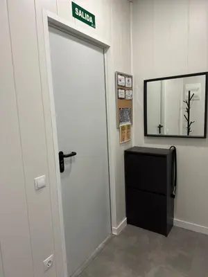 a door in a room with a mirror and a television at Sunny Terrace Apartment in Santa Coloma de Gramanet