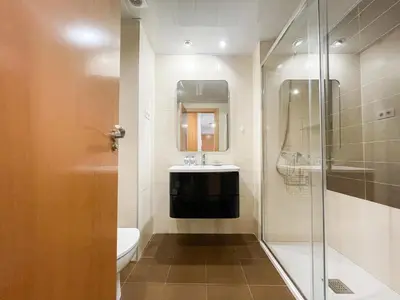 a bathroom with a sink and a glass shower at Boutique Socors in Barcelona