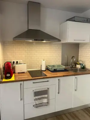 a kitchen with white cabinets and a stove top oven at Barceloneta Love 1 min to the beach in Barcelona