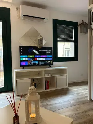 a living room with a large flat screen tv at Barceloneta Love 1 min to the beach in Barcelona