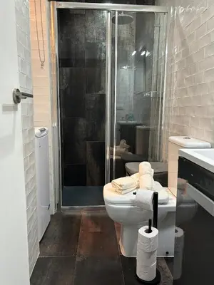 a bathroom with a toilet and a glass shower at Barceloneta Love 1 min to the beach in Barcelona