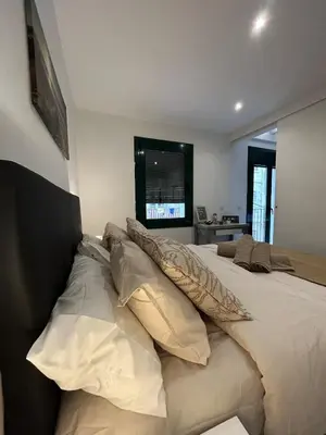 a bedroom with a large bed with pillows on it at Barceloneta Love 1 min to the beach in Barcelona