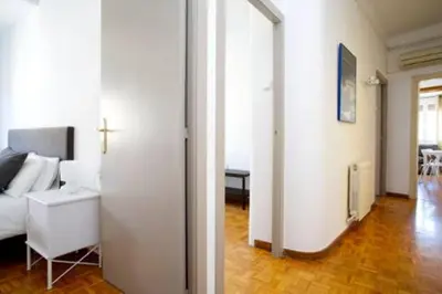 a living room with white chairs and a couch at S4D Villarroel Clinic in Barcelona