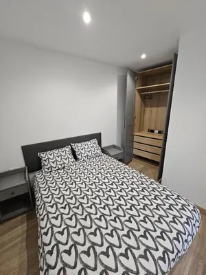 a bedroom with a black and white bed and a closet at Confort House in Argentona