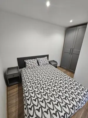 a bedroom with a bed with a black and white comforter at Confort House in Argentona