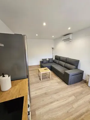 a living room with a couch and a table at Confort House in Argentona