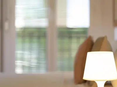a white lamp sitting in front of a couch at Winahost Barcelona Gracia in Barcelona