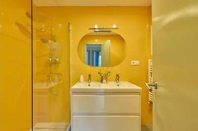 a bathroom with a sink and a shower and a mirror at Casa Cosi - Camp Nou in Barcelona