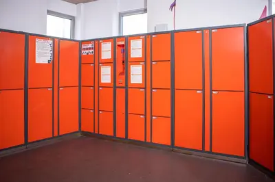 a row of orange lockers in a locker room at Urbany Hostel Barcelona in Barcelona