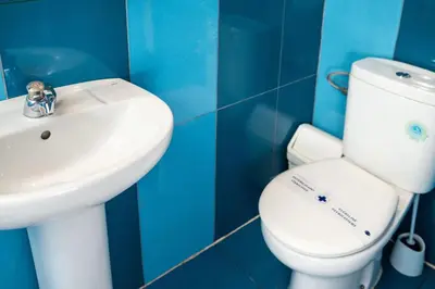 a bathroom with a white toilet and a sink at Urbany Hostel Barcelona in Barcelona