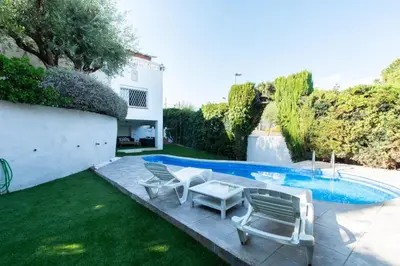 a yard with chairs and a swimming pool at Mediterranean heaven with sea views in Alella