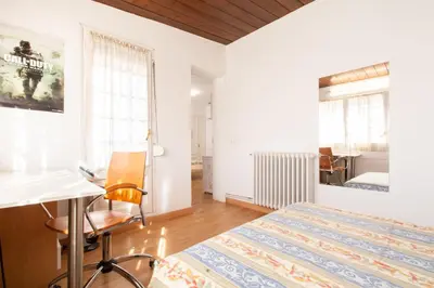 a bedroom with a bed and a desk and a desk at Mediterranean heaven with sea views in Alella