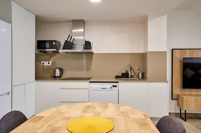a kitchen with a table with a yellow plate on it at Tr3sor 11 in Calella