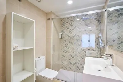 a bathroom with a shower and a toilet and a sink at Tr3sor 11 in Calella