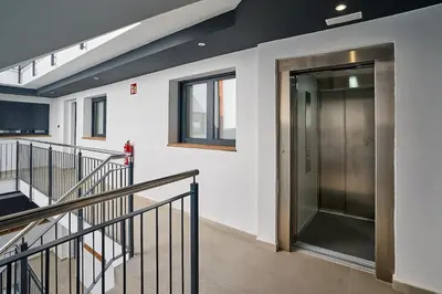a hallway with a glass door in a building at Tr3sor 11 in Calella