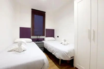 a room with two beds with swans on them at Apartment Park&Beach Deluxe in Barcelona