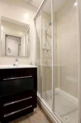 a bathroom with a glass shower and a sink at Apartment Park&Beach Deluxe in Barcelona