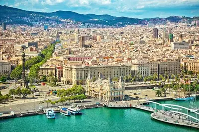 a view of a city with boats in the water at Apartment Park&Beach Deluxe in Barcelona