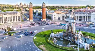 a city with a fountain in the middle of a street at Apartment Park&Beach Deluxe in Barcelona