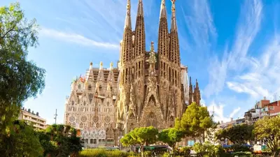 a large cathedral building with a clock tower at Apartment Park&Beach Deluxe in Barcelona