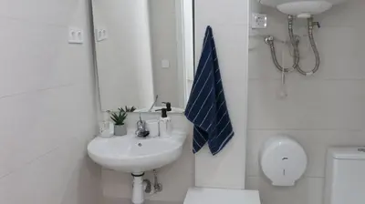a bathroom with a sink and a mirror and a toilet at El Barco Aparta Hotel in Hospitalet de Llobregat