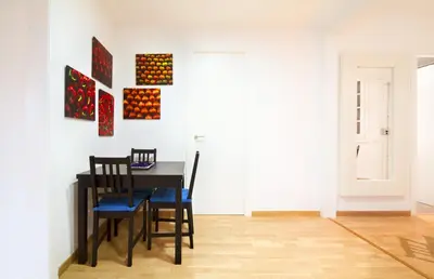 a dining room with a black table and chairs at Apartment Gaudi XL in Barcelona