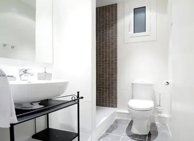 a white bathroom with a sink and a toilet at Apartment Gaudi XL in Barcelona