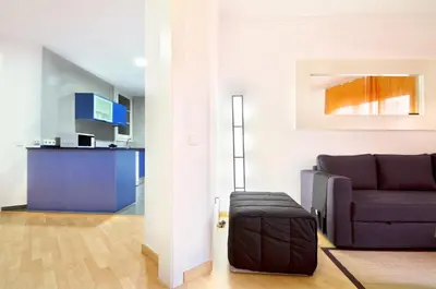 a living room with a couch and a chair at Apartment Gaudi XL in Barcelona