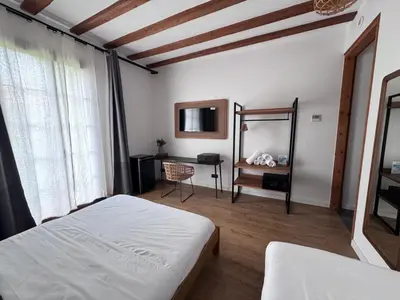 a bedroom with a bed and a desk and a mirror at Vaganto Coliving in Barcelona