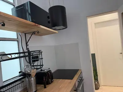 a kitchen with a counter with a microwave at Vaganto Coliving in Barcelona
