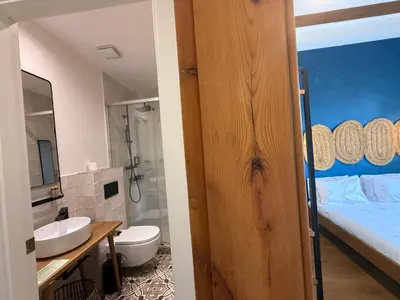 a bathroom with a bed and a sink and a toilet at Vaganto Coliving in Barcelona