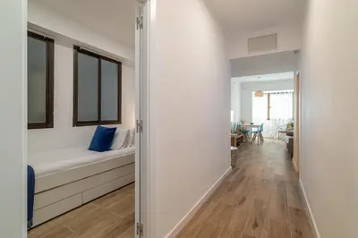 a hallway leading to a bedroom with a bed at Stay Unique Apartment Taquigraf in Barcelona