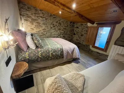 a bedroom with two beds and a window at Roca negra Montseny in Fogars de Montclus
