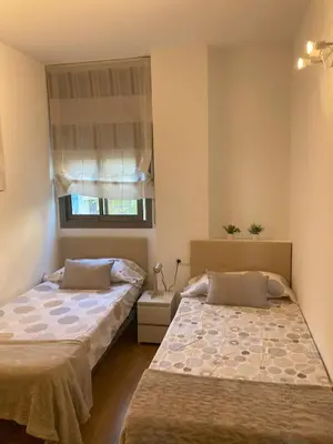 a bedroom with two beds and a window at Fantastic apartment in Barberà in Barbera del Valles