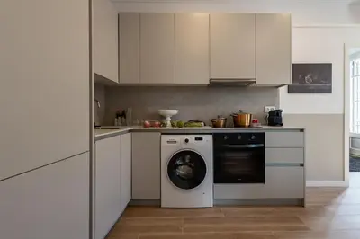 a kitchen with a washer and a washing machine at En Ville Boutique Apartments Calabria in Barcelona