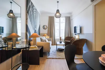 a living room with a couch and a table at En Ville Boutique Apartments Calabria in Barcelona