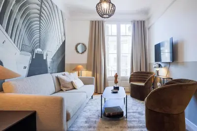a living room with a couch and two chairs at En Ville Boutique Apartments Calabria in Barcelona