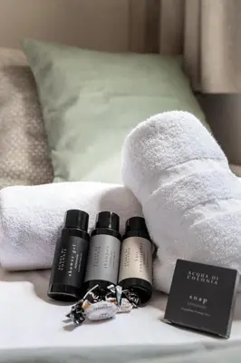 a group of three products sitting on a bed at En Ville Boutique Apartments Calabria in Barcelona