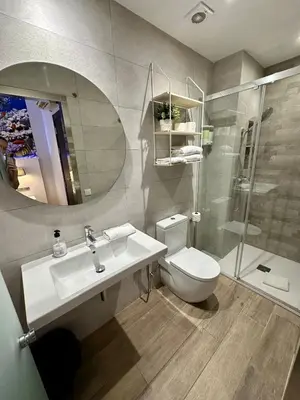 a bathroom with a sink and a toilet and a mirror at Standbyme Ramblas in Barcelona
