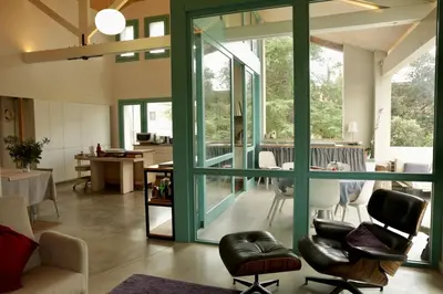 a living room with glass doors and chairs and a table at Independent duplex in a stately villa in Sant Cugat del Vallès